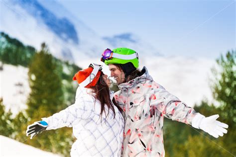 Couple In Ski Masks Looking At Each Other Happily