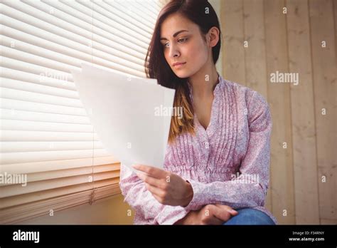 Pretty Brunette Reading Documents Stock Photo Alamy