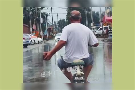 大爷雨天，一手扶把一手拿砖头，大爷拿的不是砖头是别人的素质