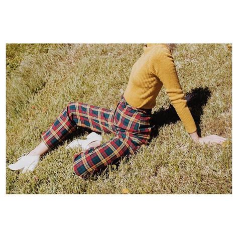 A Woman In Plaid Pants Laying On The Ground