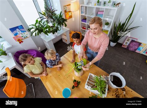 Pupils Watching Top View Of Pupils Watching Blonde Haired Teacher Using Pliers For Cutting Dry