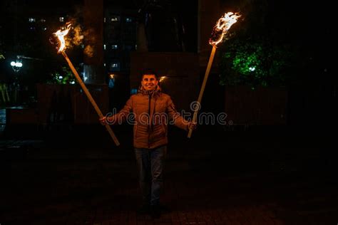 The Man Is Holding Two Torches A Peaceful Participant Of The Action