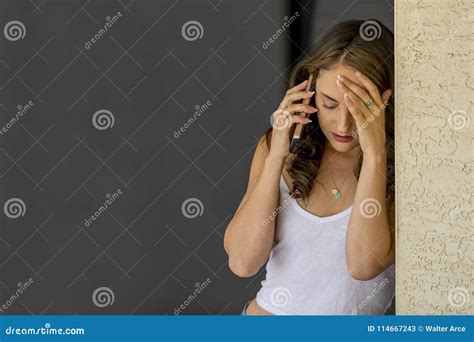 Lovely Brunette Model Posing At Home Receiving News On Her Mobile Device Stock Image Image Of