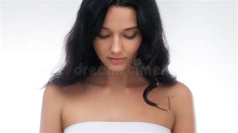 Tranquil Brunette Woman In White Top Looking Down In Studio Portrait Stock Photo Image Of