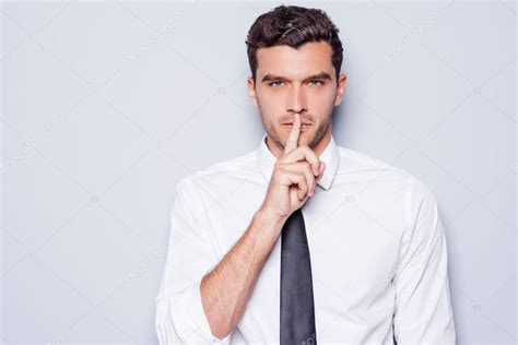 Man Holding Finger On Lips Stock Photo By Gstockstudio