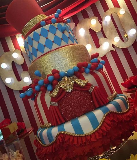 A Large Red And White Cake Sitting On Top Of A Table Next To A Sign