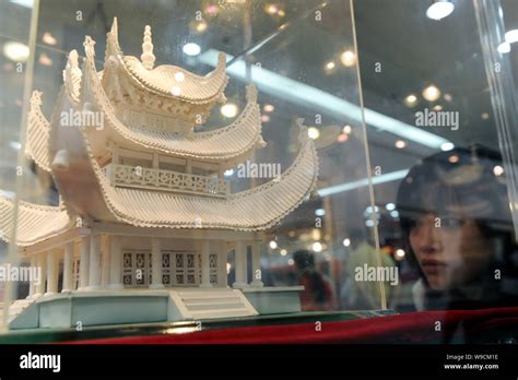 A Chinese Visitor Looks At A Paper Made Model Of Yueyang Tower Or