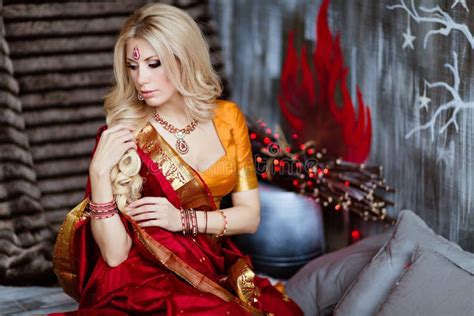 Beautiful Blonde Girl In Indian Red Saree Around The Christmas T Stock