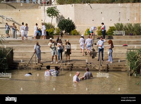 Religious Christians Immerse Themselves Into The Waters Of The Jordan