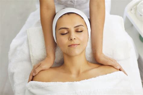 Cosmetologist Making Massage Of Face Neck And Upper Shoulder Girdle