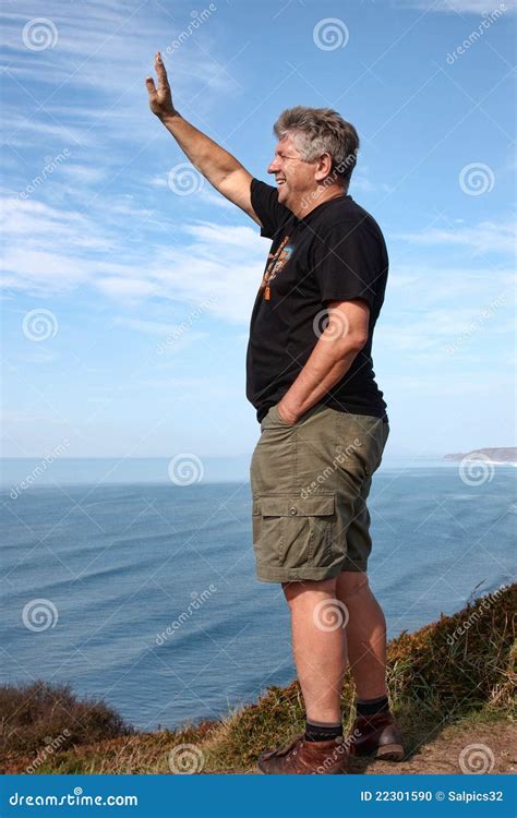 Mature Man Waving Stock Photo Image Of Vertical Cliff