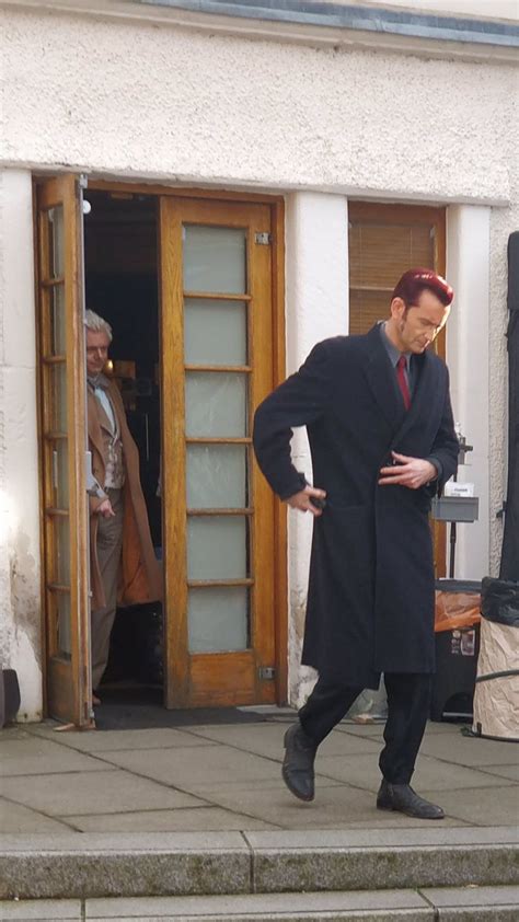 A Man In A Suit And Tie Walking Down The Street