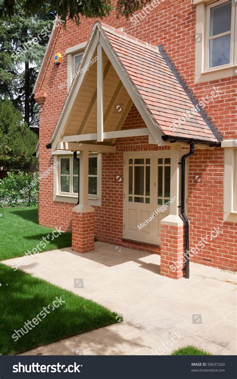 Contemporary Home With Large Pitched Roof Canopy Above The Door Stock