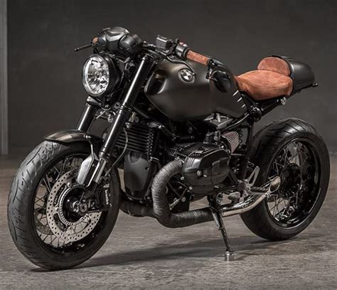 A Black Motorcycle Parked On Top Of A Cement Floor