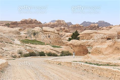 Tourist Exploring The Ruins Of Ancient Petra Jordan