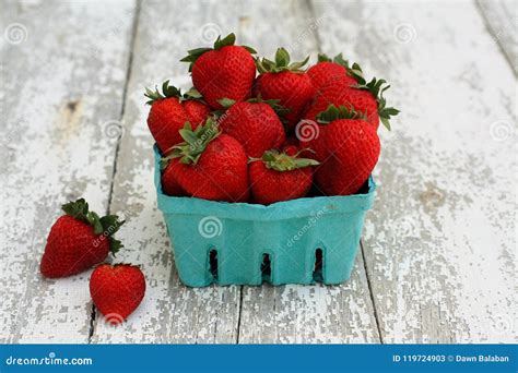 Strawberries In A Green Paper Carton On White Wood Stock Image Image