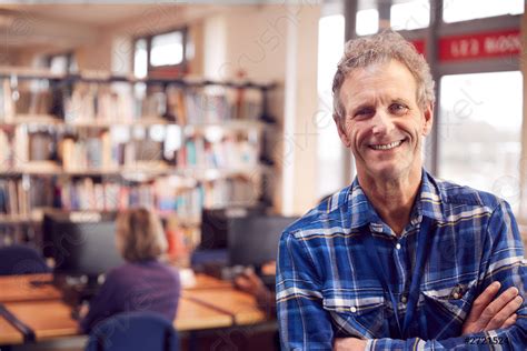 Portrait Of Mature Male Teacher Or Student In Library With Stock Photo Crushpixel