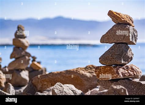 Stacked rocks balanced on the beach Stock Photo - Alamy