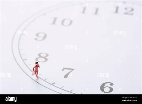 Miniature Doll Woman Running Around A Clock Face Stock Photo Alamy