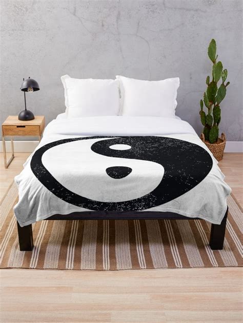 A Black And White Yin Symbol On A Bed