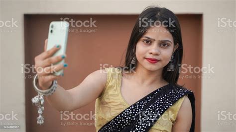 Beautiful Indian Girl Taking Selfie On Her Mobile Phone Outdoor