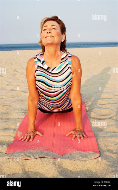 Mature Woman Exercising On The Beach Stock Photo Alamy
