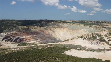 Aerial View Industrial Of Opencast Mining Quarry With Lots Of Machinery