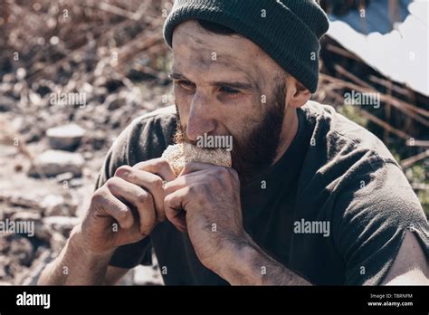 Poor Homeless Man Eating Bread Outdoors Stock Photo Alamy