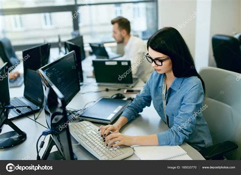 Young Woman Working And Programming On Computer In Office Stock Photo