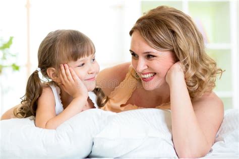 Mentira Feliz De La Mamá Y De La Hija En Cama Foto De Archivo Imagen