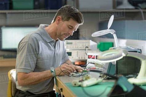 Electronics Engineer Assembling Components In Electronics Factory