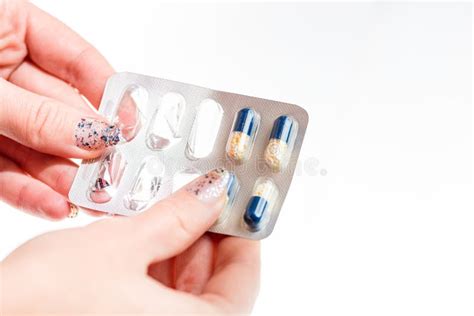Hand Holding Antibiotics Capsules Or Painkillers Isolated On White