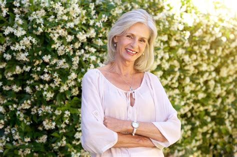 Premium Photo Older Woman Smiling And Standing Outside In Spring