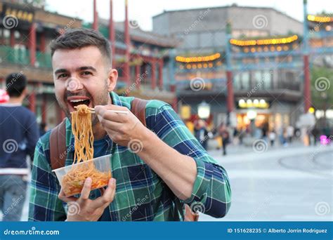 Cute Guy Eating Asian Noodles Outdoors Stock Image Image Of Away