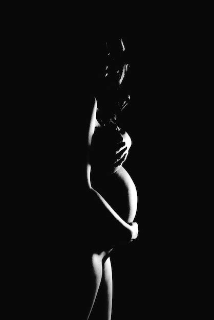 Premium Photo Naked Pregnant Woman Covering Breasts Against Black Background