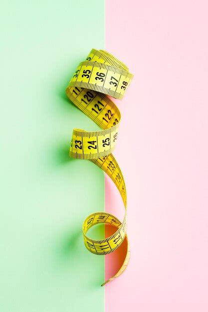 Premium Photo | Yellow measuring tape of the tailor on colorful background