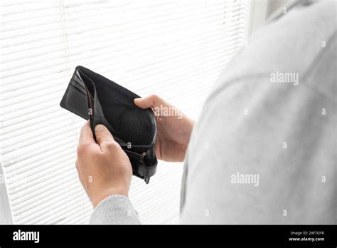 A Man Holding An Empty Wallet Close Up Hands Of Poor Man Open Empty