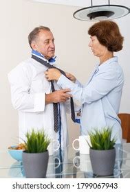 Portrait Smiling Mature Woman Adjusting Tie Stock Photo 1204970038