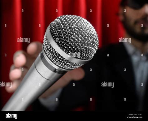 A youg man on stage about to grab a microphone Stock Photo - Alamy