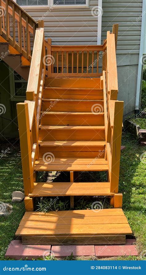 Outdoor Wooden Staircase Leading Up To A Single Story Home Stock Photo