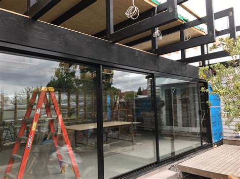 An Outdoor Area With Tables And Ladders In Front Of The Windows That