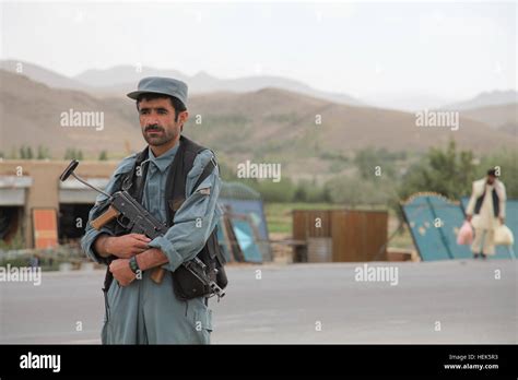 An Afghan National Policeman Stands Guard During A Presence Patrol With