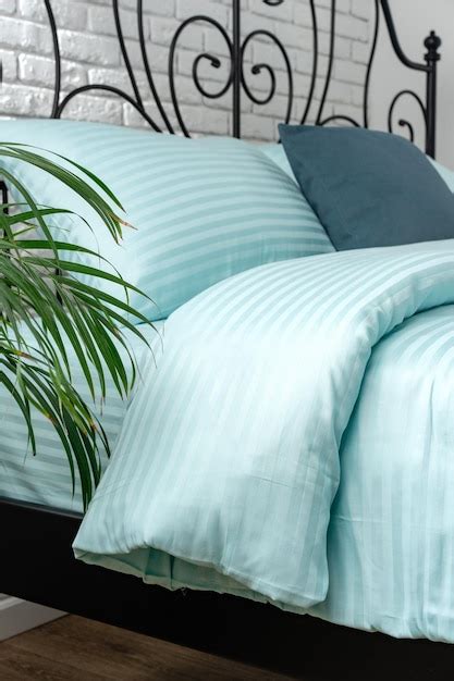 Mint Green Striped Bedding On A Black Metal Frame Bed Premium Ai