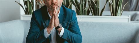 Busy Mature Businessman Workingon Laptop While Sitting In Modern