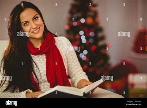 Pretty Brunette Reading On Couch At Christmas Stock Photo Alamy