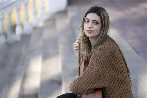Dreamy And Touched Tender Blonde Woman Plays Guitar With Pleased Kind Smile Stock Image Image