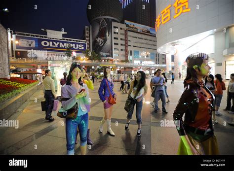 People Take Pictures With Sculpture Featuring Fashion Youth In A