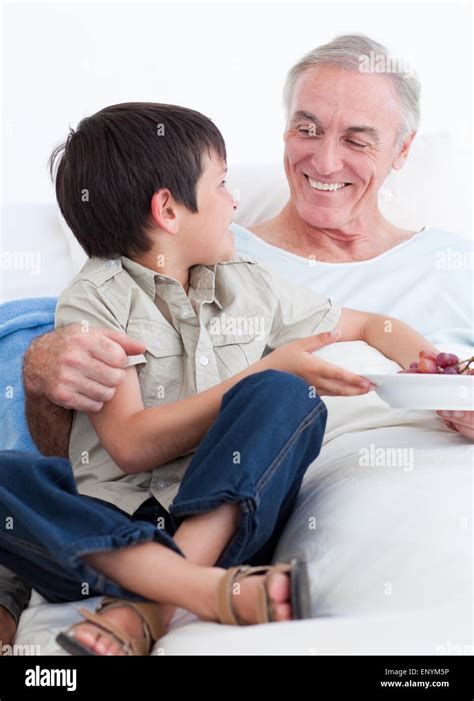 Adorable Little Boy Taking Care Of His Grandfather Stock Photo Alamy