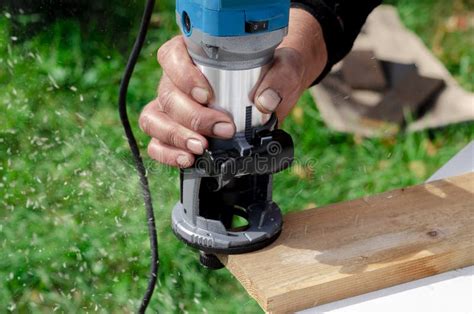 Closeup Of Carpenter With Hand Wood Router Machine At Work Closeup Of