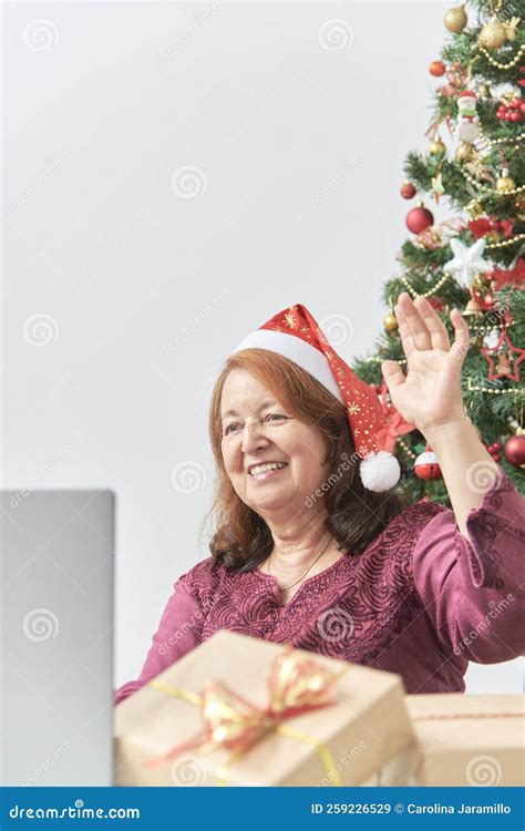 Mature Hispanic Woman Greeting Her Loved Ones Via Video Call During